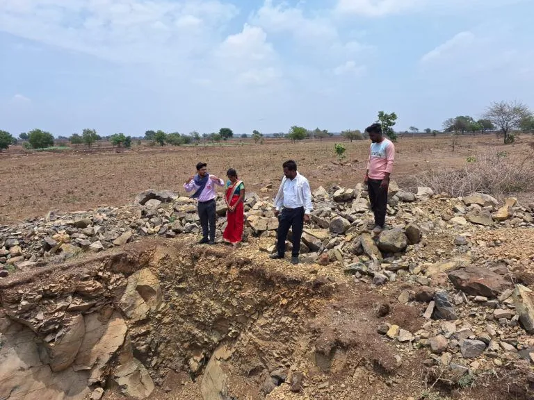 A dug out farm pond or recharge pit filled with water
